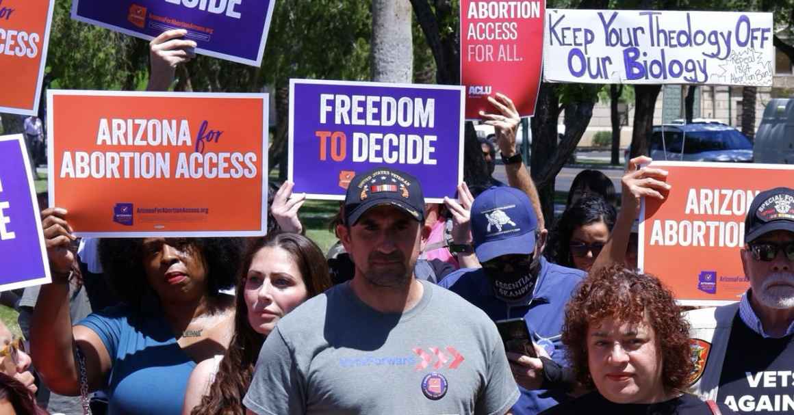 Group of people holding signs supporting abortion rights. 